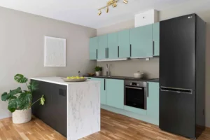 Blue matte kitchen cabinets with dark handles and a light island, from the INNOVA catalogue ASA 1010 application.
